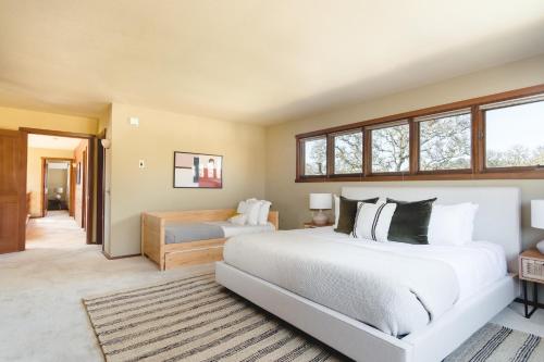 a bedroom with two beds and a large window at Gable by AvantStay Beautiful 3.5 Acre Oasis w Gorgeous Views Pool Hot Tub in Santa Rosa
