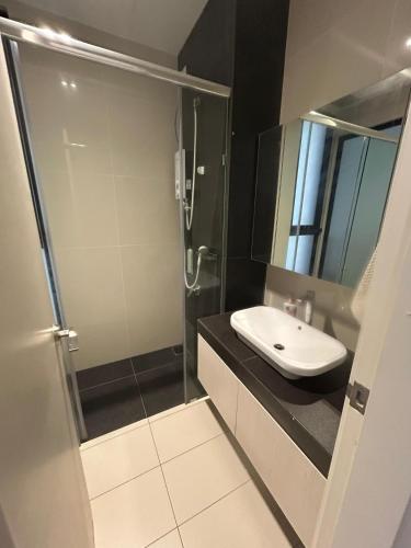 a bathroom with a sink and a shower at Eco Nest 3 Bedroom Duplex Apartment in Nusajaya