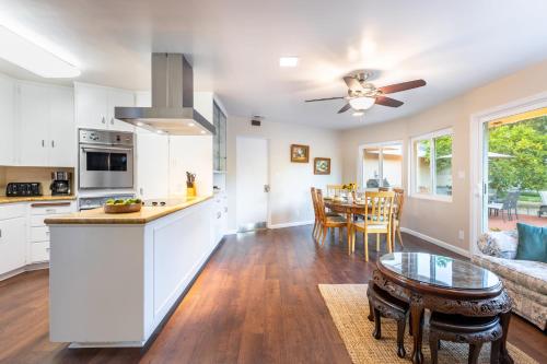 a kitchen and living room with a table and a couch at East Valley Manor by AvantStay Minutes to the Beach in Montecito