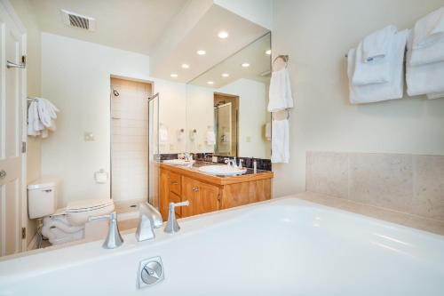 a bathroom with a tub and a sink and a toilet at Etta Place Too 113 by AvantStay Close to Town The Slopes In Complex w Communal Pool Hot Tub in Telluride