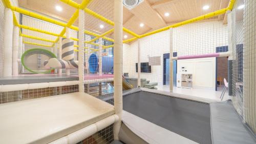 a view of a gym with yellow beams at Yeosu Kinolkids Poolvilla in Yeosu