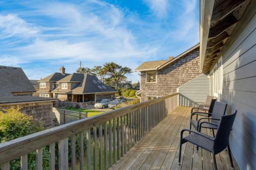 a deck with two chairs and a house at Royal Canoe by AvantStay Walk to the Shore Private Yard in Arch Cape
