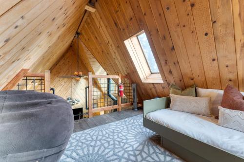 a living room with a couch in a attic at Jeffrey Pines Lofted Cabin Minutes to Lake A-Frame-Inspired Design Deck in Truckee