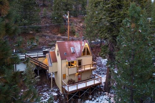 an aerial view of a house in the woods at Jeffrey Pines Lofted Cabin Minutes to Lake A-Frame-Inspired Design Deck in Truckee