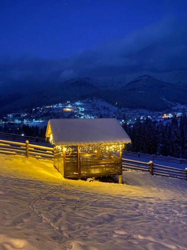 a building covered in lights on the side of a mountain at Мелодія Гір Вид на гори in Vorokhta