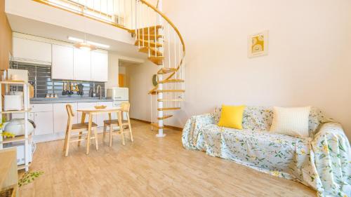 a living room with a couch and a table at Chuncheon Lio Pension in Chuncheon