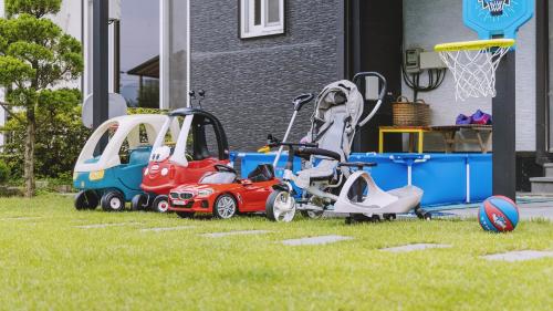 a group of toy cars parked in a yard at Yangpyeong The On Private Kids Pension in Yangpyeong