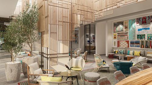 a lobby of a store with chairs and tables at Rove Al Marjan Island in Ras al Khaimah