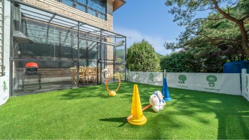a yard with some toy cones on the grass at Pocheon luxjay pet Pension in Pocheon