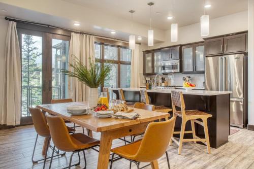 a kitchen and dining room with a wooden table and chairs at Kestrel by AvantStay Close to the Ski Slopes in this Majestic Home in Park City in Park City
