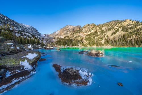 a view of a blue lake in the mountains at Three-Bedroom Apartment in Estes Park