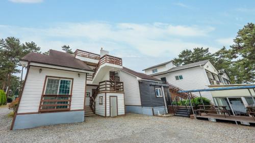 a house that is sitting on a gravel driveway at Taean Mongsanpo and the Sea Pension in Taean