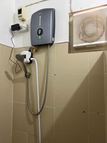 a shower in a bathroom with a phone on the wall at Solo Hiding Place in Pilar