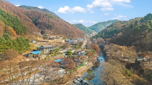 an aerial view of a river in a valley at Gapyeong dolgungpensyeon&kaempingjang in Gapyeong