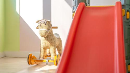 a stuffed camel riding a skateboard down a slide at Gyepngju Camino Pool Villa in Gyeongju