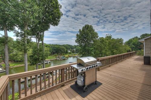 a grill on a deck overlooking a river at Shades of Summer by AvantStay Gazebo Dock View in Cornelius