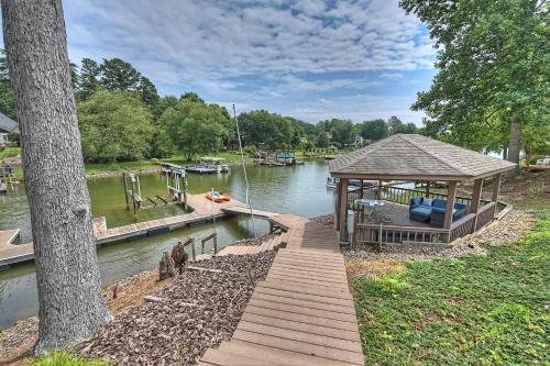 a dock with a gazebo next to a river at Shades of Summer by AvantStay Gazebo Dock View in Cornelius