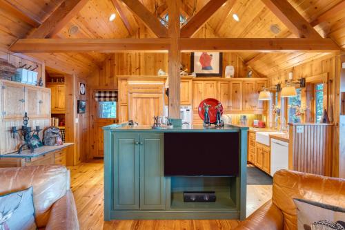a kitchen with a large blue island in a cabin at Homewood Lakefront by AvantStay Private Beach Lake Access Views in Homewood