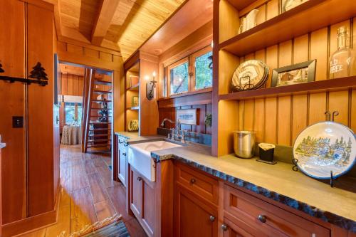 a kitchen with wooden walls and wooden counters at Homewood Lakefront by AvantStay Private Beach Lake Access Views in Homewood