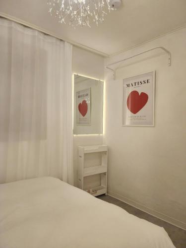a bedroom with a bed and two hearts on the wall at Gyedong byeolchae, Bukchon hanok village & Namsan tower city view Warm morning sunshine Tranquil Rest in Seoul