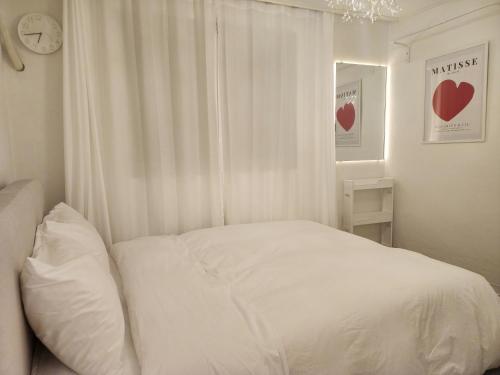 a bedroom with a white bed and a window at Gyedong byeolchae, Bukchon hanok village & Namsan tower city view Warm morning sunshine Tranquil Rest in Seoul
