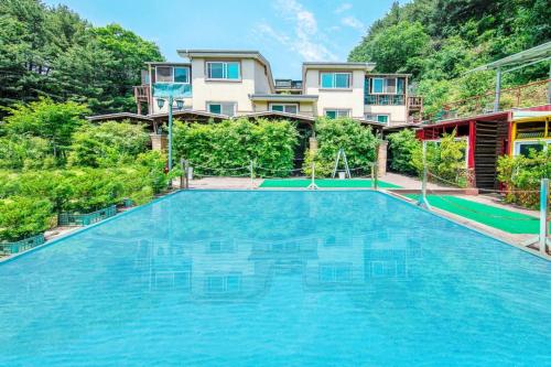 an image of a swimming pool in front of a house at Gapyeong Swimteo Pet Pension in Gapyeong