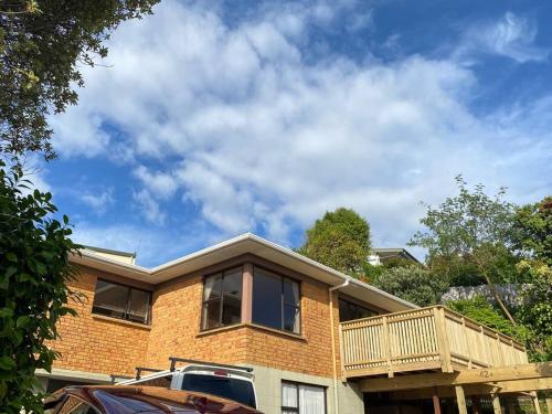 a brick house with a balcony on top of it at Seaview house in Howick Auckland in Auckland