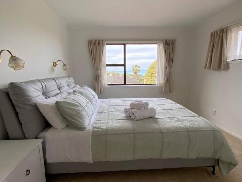 a bedroom with a bed with a stuffed animal on it at Seaview house in Howick Auckland in Auckland