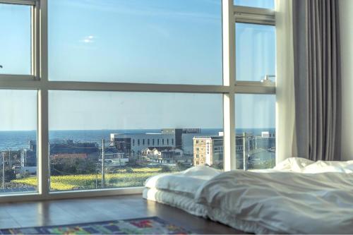 Postel nebo postele na pokoji v ubytování Jeju Sky Kids Pension