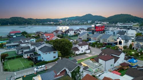 an aerial view of a town next to a river at daebudo uramstay pension in Ansan