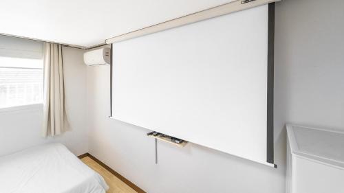 a bedroom with a bed and a window at Yeongheungdo Ttobagi Pension in Incheon