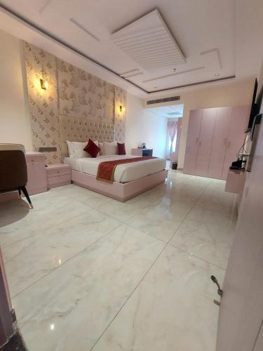 a large room with a bed and a couch at Hotel Yathin in Mysore