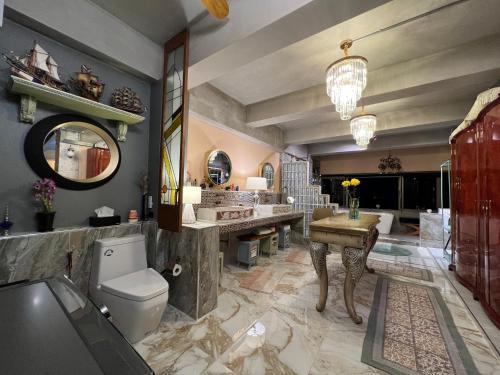 a bathroom with a toilet and a sink and a mirror at Luxury Apartment in Nimman, 5 mins to Maya in Chiang Mai