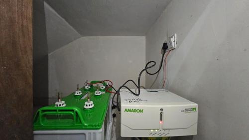 a small room with a green table and a machine at Kutir Stay in Secunderabad