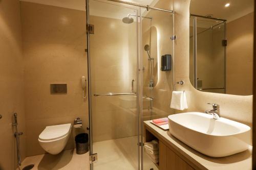 a bathroom with a sink and a shower at Tulip Inn Zirakpur in Chandīgarh