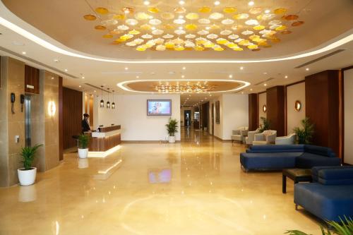 a lobby of a hotel with a large ceiling at Tulip Inn Zirakpur in Chandīgarh