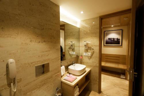 a bathroom with a sink and a mirror at Tulip Inn Zirakpur in Chandīgarh
