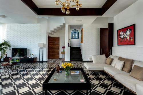 a living room with a couch and a table at La Maroma 3 BHK Splendid Villas in Anjuna - Pvt Pool- Garden & Caretaker in Vagator