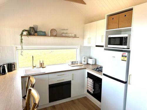 a kitchen with a white refrigerator and a sink at The Bay overlooking Boston Island in North Shields