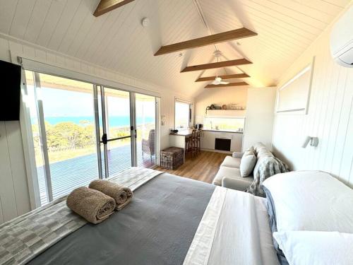 a bedroom with a large bed and a living room at The Bay overlooking Boston Island in North Shields