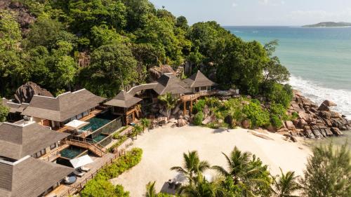 an aerial view of a resort on a beach at Constance Lemuria in Grand'Anse Praslin