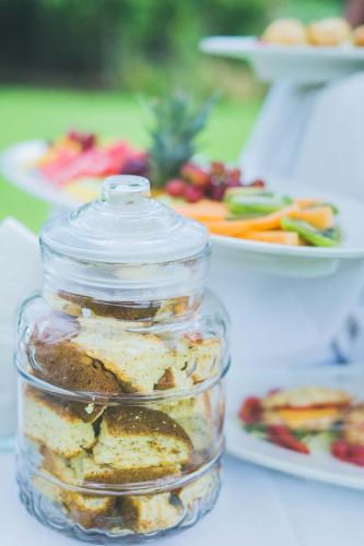 a jar of food on a table with plates of food at The Blades in Pretoria