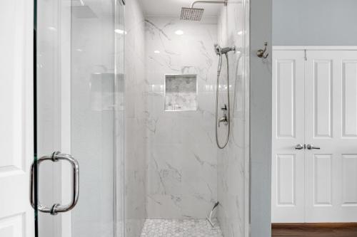 a bathroom with a shower with a glass door at Encantamar Escape by AvantStay Prime Location Community Amenities in Dana Point