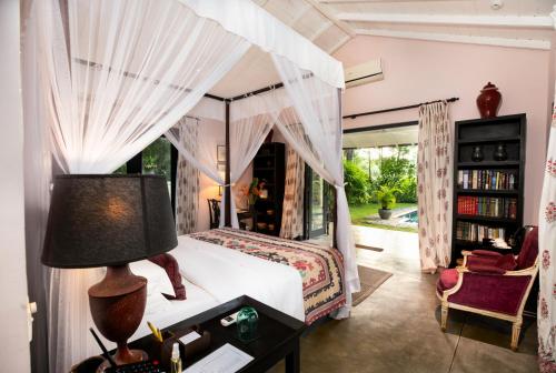 a bedroom with a bed with a canopy at Kahanda Kanda in Koggala