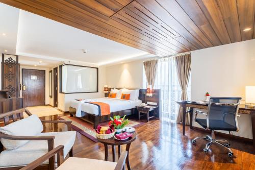a hotel room with a bed and a desk at Ramada by Wyndham Kathmandu Dhumbarahi in Kathmandu