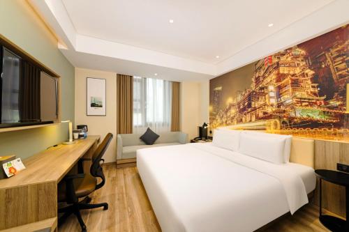 a hotel room with a large bed and a desk at Atour Hotel Chongqing Jiefangbei in Chongqing