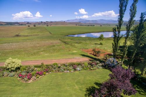 an aerial view of a garden and a pond at Chikanka in Himeville