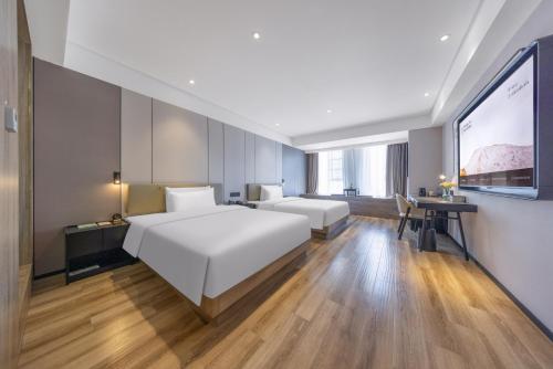 Ένα ή περισσότερα κρεβάτια σε δωμάτιο στο Atour Hotel Kunming Dianchi Lake