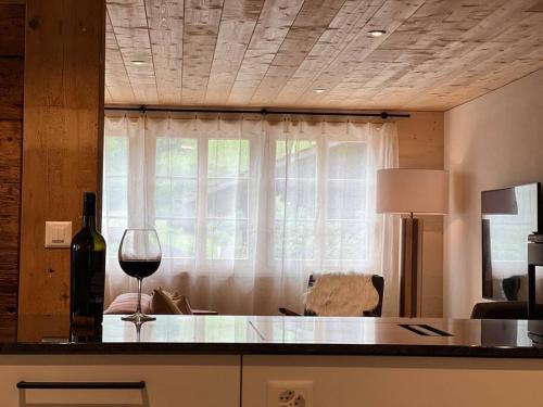 a wine glass sitting on a counter in front of a window at Hidden Retreats 1466 Edition in Reichenbach