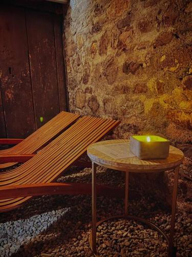 a candle sitting on a table next to a bench at Hidden Retreats 1466 Edition in Reichenbach